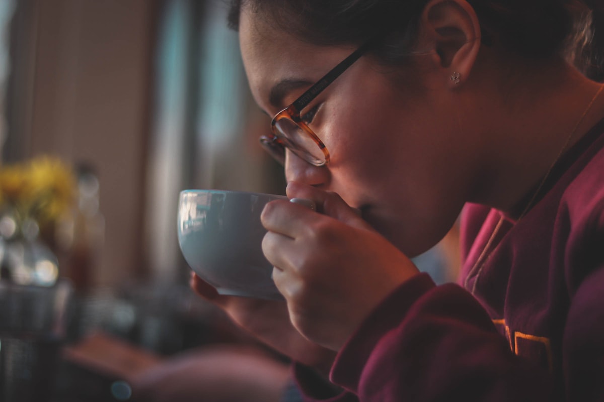 Man enjoying morning coffee with sunrise